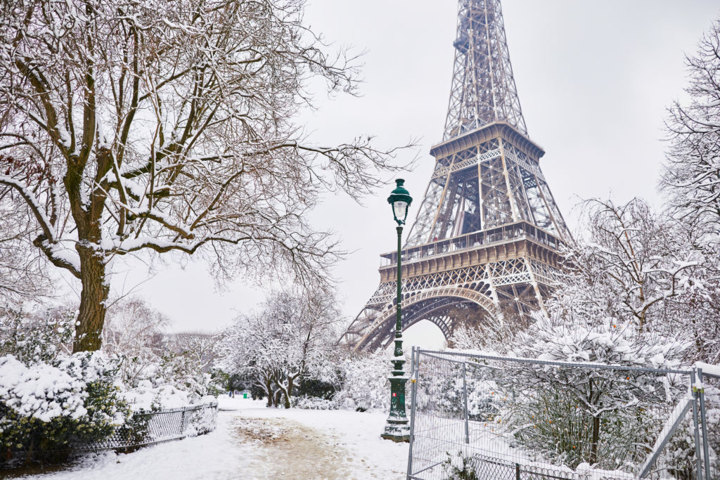 View of the Eiffel Tower and surrounding park on a snowy day