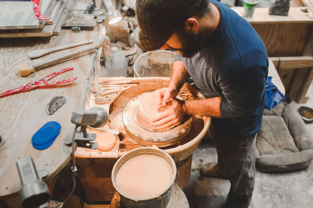 Man working at a potter's wheel at Earth, Fire, & Spirit Pottery in Lexington, Virginia, United States